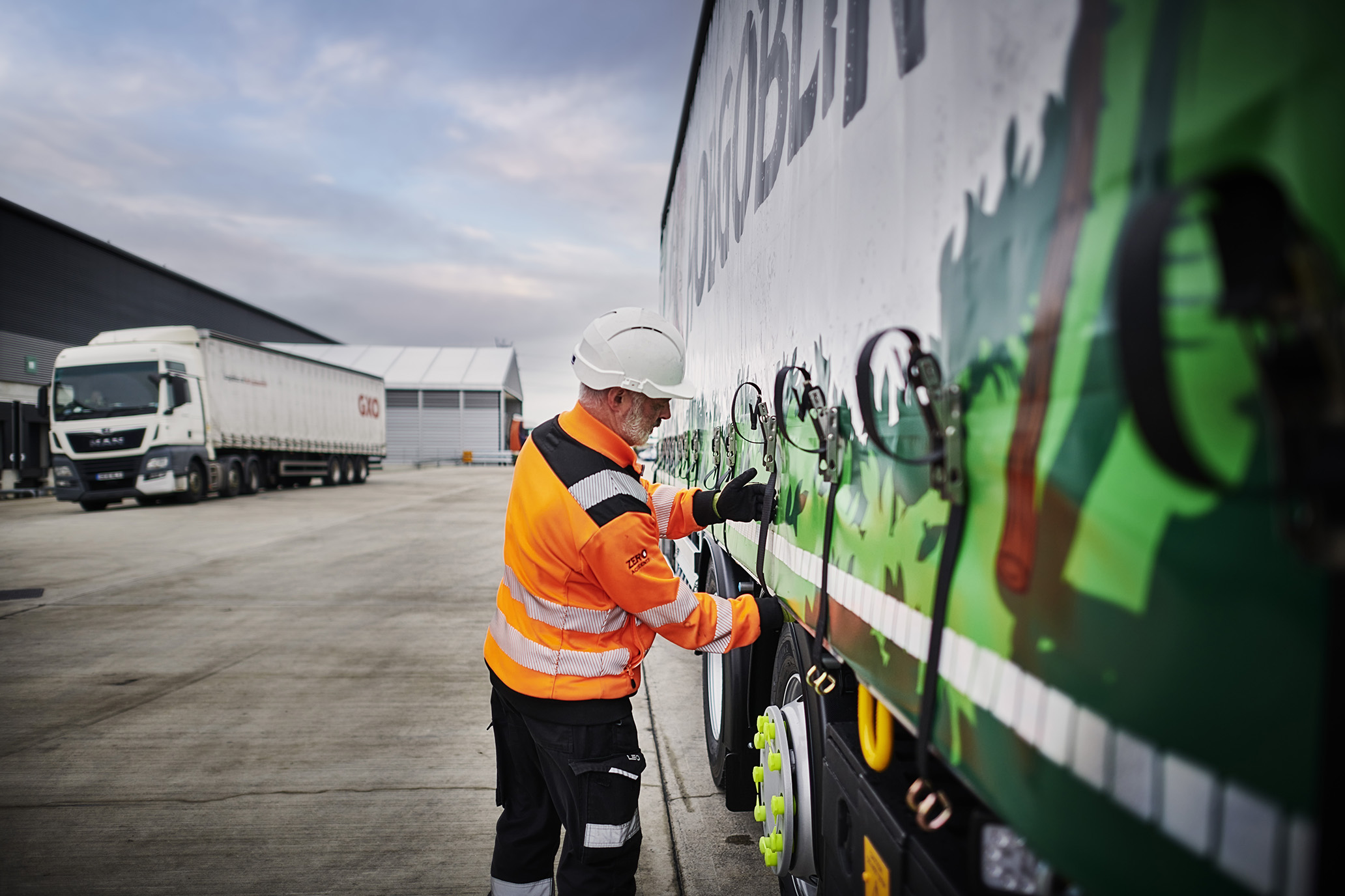 Person checking straps on truck 2.jpg