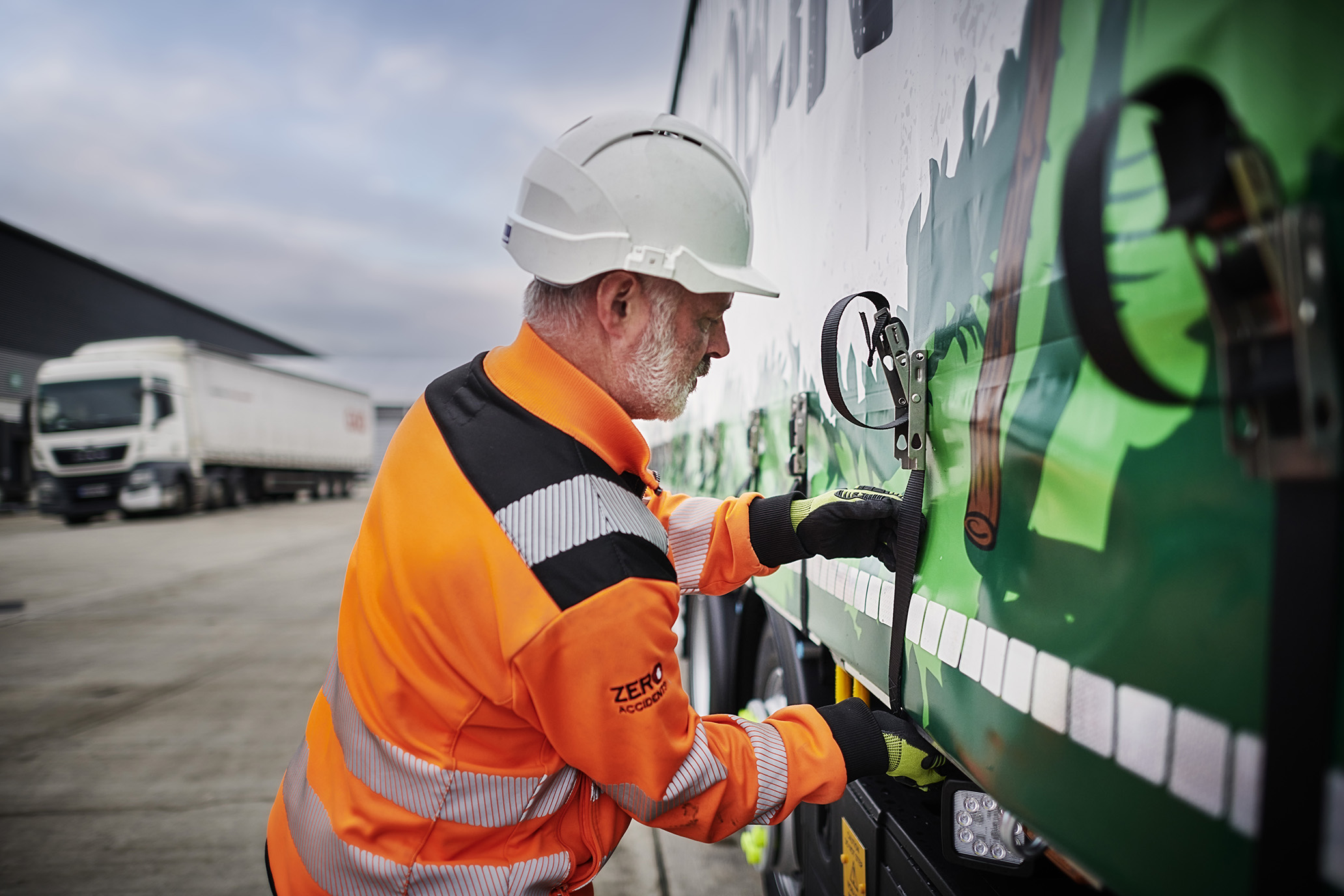 Person checking straps on truck.jpg